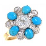 A TURQUOISE AND DIAMOND CLUSTER RING, C1900 with larger central old cut diamond, in gold with fluted