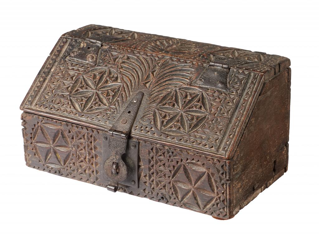 A NORTHERN EUROPEAN CHIP CARVED OAK CASKET, 17TH C of boarded construction, the front, top and