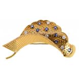 CARTIER. A SAPPHIRE AND DIAMOND STYLISED LEAF BROOCH, MID 20TH C the stippled 'lip' patterned with