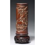 A CHINESE BAMBOO BRUSH POT carved with a continuous scene of figures and animals amidst trees and