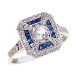 A DIAMOND AND SAPPHIRE RING with larger old cut diamond in a surround of calibre cut sapphires, in