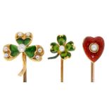 THREE GOLD STICKPINS, C1900 each with seed pearl and green or cherry red guilloche enamel