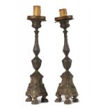 A PAIR OF CONTINENTAL BRASS ALTAR STICKS, THE SCONCE AND BASE 17TH C on three cast paw feet, 44cm