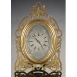 A FRENCH GILT BRASS STRUT CLOCK, LATE 19TH C the engine turned and silvered oval dial in foliate