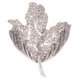 RENE KERN. A DIAMOND BROOCH, C1960 designed as a flower with round brilliant and baguette cut