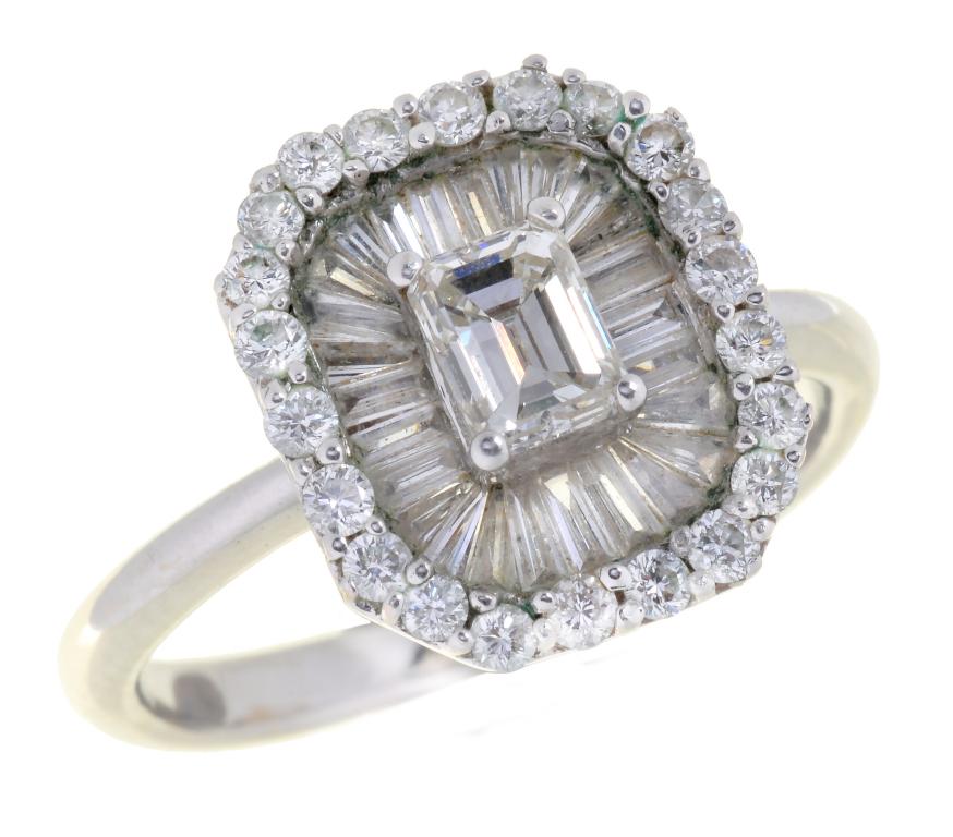 A DIAMOND CLUSTER RING with larger central emerald cut diamond, in white gold marked 18K and DO 41