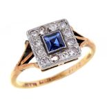 A SAPPHIRE AND DIAMOND CLUSTER RING with central step cut sapphire, gold hoop, marked 18 CT PLAT,