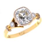 A DIAMOND RING with cushion shaped old cut diamond and diamond set shoulders, in gold, marked