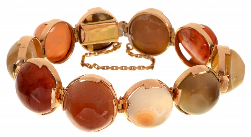 A GOLD AND HARDSTONE BRACELET with ten banded or other agate cabochons, graduated from the centre,