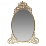 A VICTORIAN OVAL BRASS DRESSING MIRROR with engraved fretwork cresting and feet, pierced strut, 75cm
