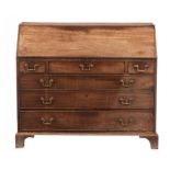 A GEORGE III MAHOGANY BUREAU, C1800 the fitted interior centred by a door with oval patera, 106cm h;