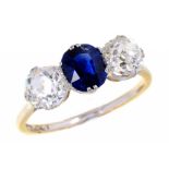 A SAPPHIRE AND DIAMOND THREE STONE RING, early 20th c with old cut diamonds, gold hoop, 3.1g, size