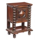 AN ITALIAN WALNUT CUPBOARD, EARLY 17TH C the moulded breakfront top on spiral pilasters flanking
