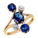 A SAPPHIRE AND DIAMOND RING the three inline sapphires with smaller diamonds, in gold with forked