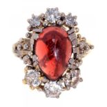 A GARNET AND DIAMOND CLUSTER RING the garnet cabochon approx 13 x 10mm the six round cut diamonds