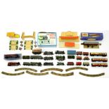 A QUANTITY OF HORNBY DUBLO LOCOMOTIVES AND ROLLING STOCK, STATION AND OTHER BUILDINGS AND THREE RAIL