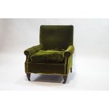 An Edwardian armchair with turned mahogany legs, upholstered in green velvet,