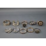 Ten various silver and white metal rings including a blue paste three stone ring and a marcasite