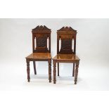 A pair of Victorian mahogany hall chairs,