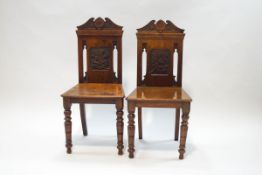 A pair of Victorian mahogany hall chairs,