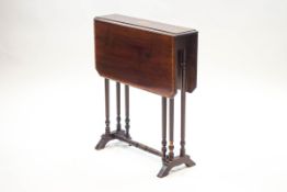 An Edwardian mahogany Sutherland table, crossbanded with inlaid paterae, on turned legs,