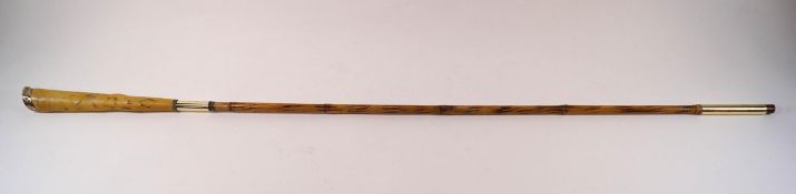 A slim ladies' cane with long faux ivory handle and yellow metal mount