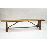 A Continental fruitwood bench with 'A' shape supports,