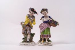 A pair of 19th century Sampson porcelain figures of a girl with a basket of flowers and a boy with