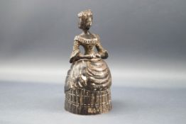A late 19th century Continental silver table bell in the form of an 18th century lady wearing a