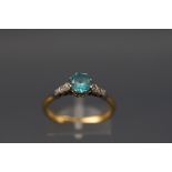 An early 20th century gold, blue zircon and diamond ring,