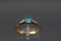 An early 20th century gold, blue zircon and diamond ring,