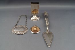 A silver handled miniature presentation type trowel with a plated blade,