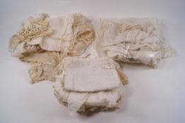 A quantity of lace and embroidered fragments including some collars and bonnets,