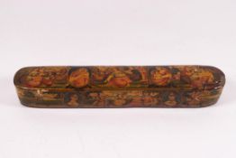 A Quajar lacquered pen box, decorated with multiple figures, 23.