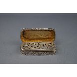 A Victorian silver shaped-oblong vinaigrette, engraved all over with foliate scrolls and diaper,