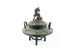 A Chinese bronze two handled pot and cover,