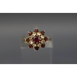 A garnet and paste cluster ring, stamped 'silver', size I+.