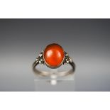 An oval cabochon carnelian single stone ring, marked 'Sterling silver', size M.