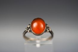 An oval cabochon carnelian single stone ring, marked 'Sterling silver', size M.