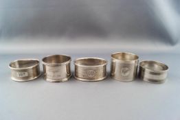 Five various English silver napkin rings, some inscribed, various dates and makers, 102g gross.