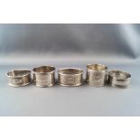 Five various English silver napkin rings, some inscribed, various dates and makers, 102g gross.