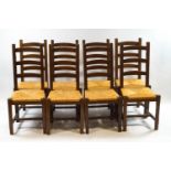 A set of eight 20th century ladderback dining chairs with rush seats