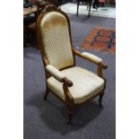 A Victorian beech show frame armchair, scroll arms and carved acanthus leaf legs,