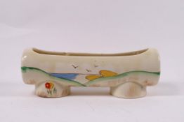 A Clarice Cliff planter painted with a tree to one side and a coastal landscape to the other,