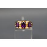 An 18ct gold, amethyst and diamond dress ring,