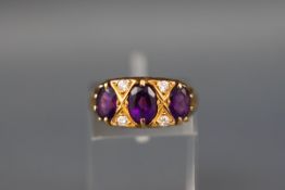 An 18ct gold, amethyst and diamond dress ring,
