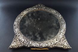 A silver mounted round easel-back dressing table mirror,