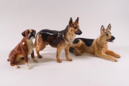 Two Beswick figures of German Shepherds, one recumbent, and a Beswick Boxer dog,