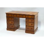 A Victorian pitch pine pedestal desk with bamboo effect detail,