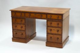 A Victorian pitch pine pedestal desk with bamboo effect detail,